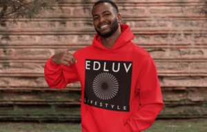 A man wearing a red hoodie with an edluv lifestyle logo on it.