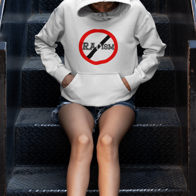 A person sitting on some steps wearing shorts and a hoodie