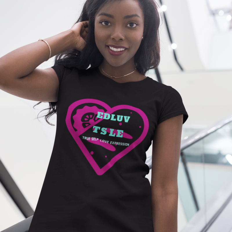 A woman wearing a black t-shirt with pink heart and words.