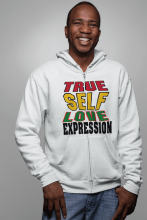 A man wearing a white hoodie with the words " true self love expression ".