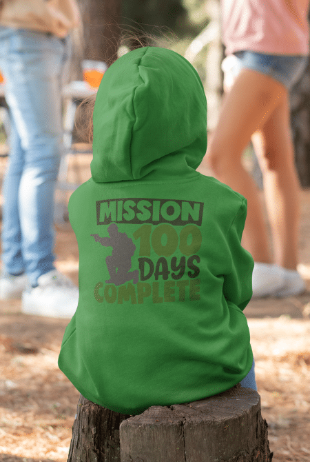 A person wearing a green hoodie with the words " mission 1 0 0 days complete ".