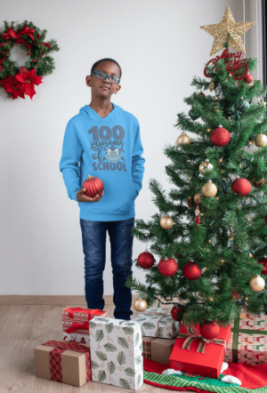 A boy standing in front of a christmas tree.