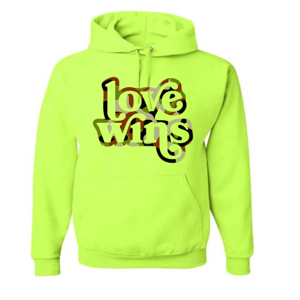 A neon yellow hoodie with the words love wins written on it.