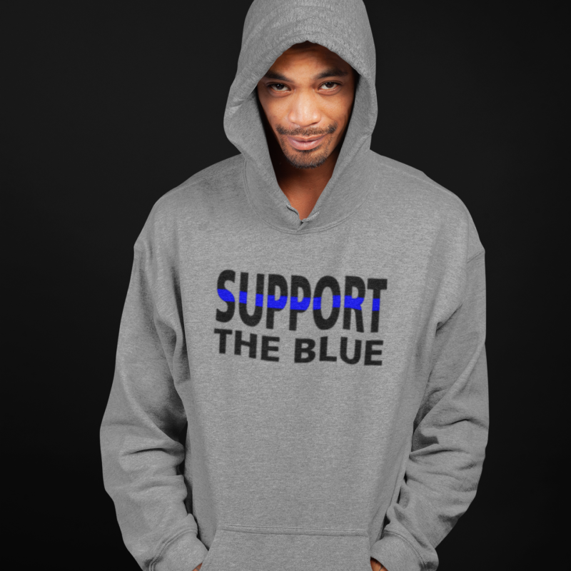 A man in grey hoodie with support the blue written on it.