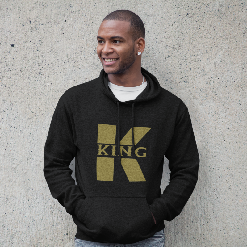 A man wearing a black and gold hoodie.