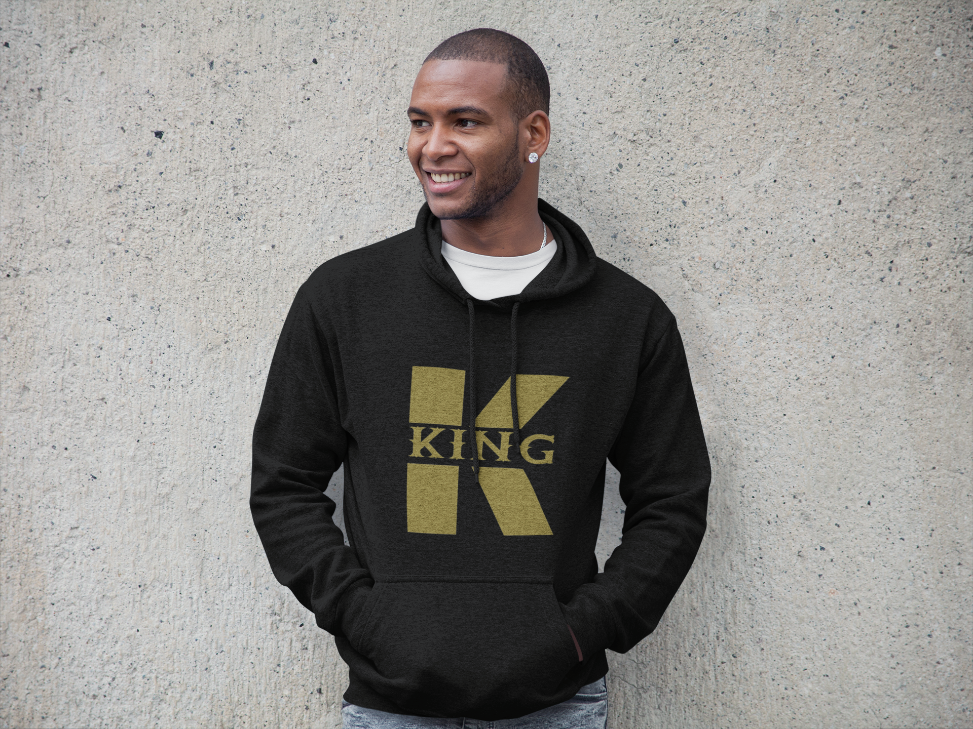 A man wearing a black and gold hoodie.