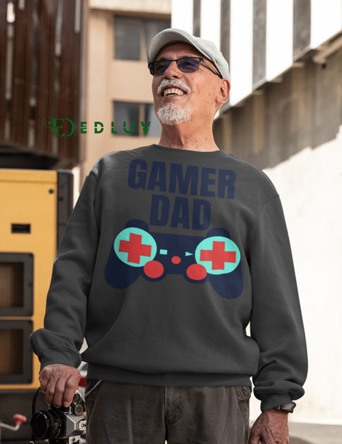 A man wearing a sweater with the words gamer dad on it.