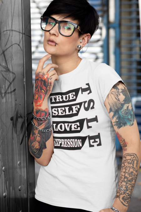 A woman with tattoos and piercings wearing a white shirt.