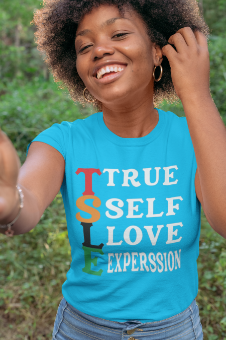 A woman wearing a blue shirt with the words " true self love expression ".