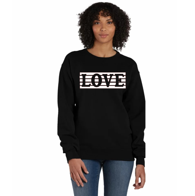 A woman wearing a black sweatshirt with the word love on it.